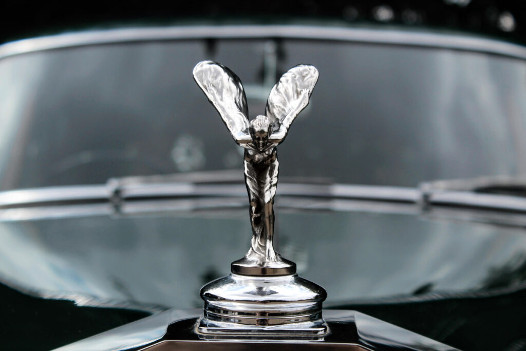 Close up of the Spirit of Ecstasy on a green Rolls Royce Silver Cloud