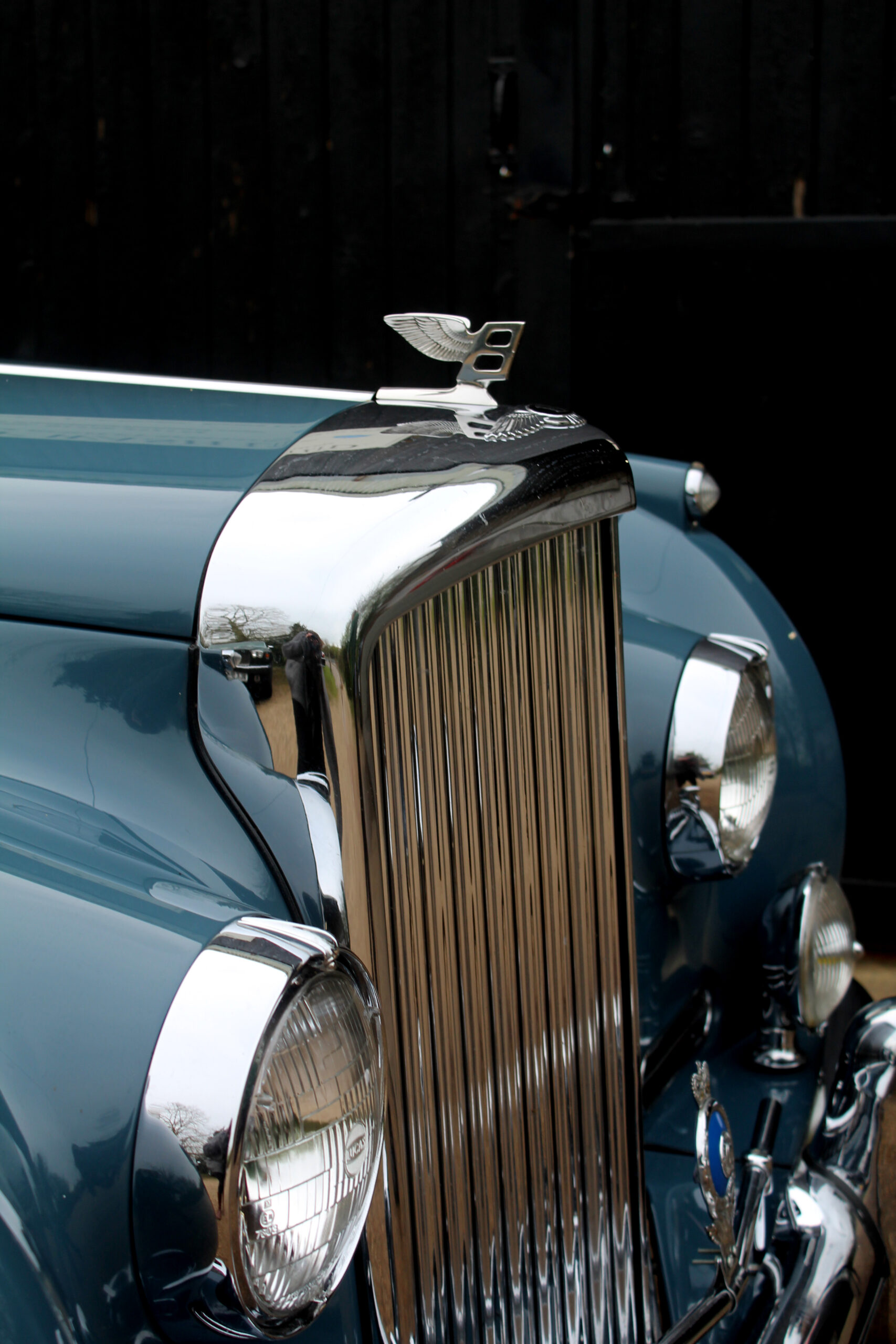 three quarters view of Bentley S1 continental grill, and headlights. Bentley is powder blue.