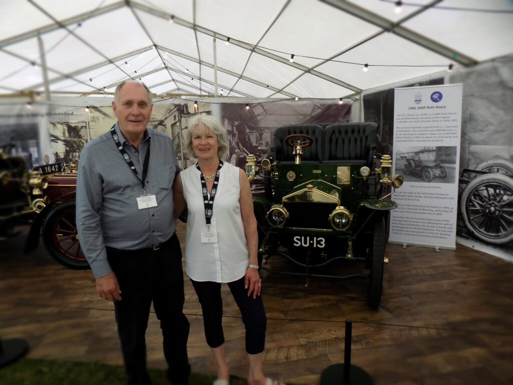 Harvey and andrea wash founders of Harvey Wash Lrd, standing next to classic car 