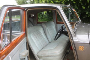 Rolls Royce Silver Dawn interior view throgh drivers door. Interior is light grey.