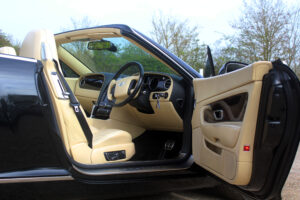magnolia leather seats and interior of Bentley GTC, view through drivers door